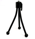 Compact black iron mini tripod with ball head, folded next to an iPhone for scale.