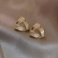 Women's metal oil stud earrings with inlaid zircon, geometric triangle shape, yellow gold finish on copper