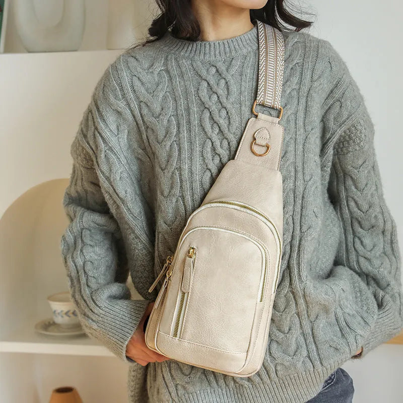 Soft PU women's crossbody chest bag in street style, showing internal zipper organisers.