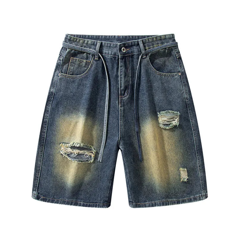 A pair of retro blue loose fit men's jeans with ripped detailing on the legs.