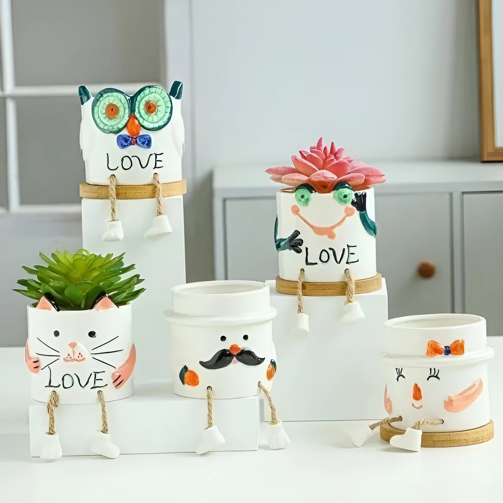 Cartoon-style ceramic hanging foot flower pot for succulent plants on a desktop.