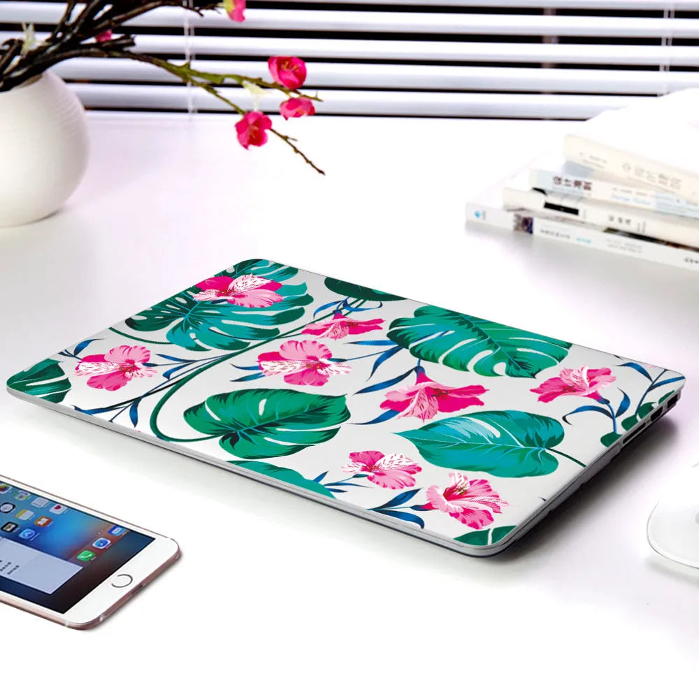 MacBook protective shell with floral pattern design covering laptop top and bottom surfaces