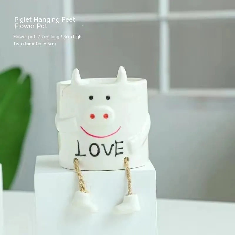 Ceramic hanging foot flowerpot in a cartoon style, shown as a desktop planter for succulent plants.