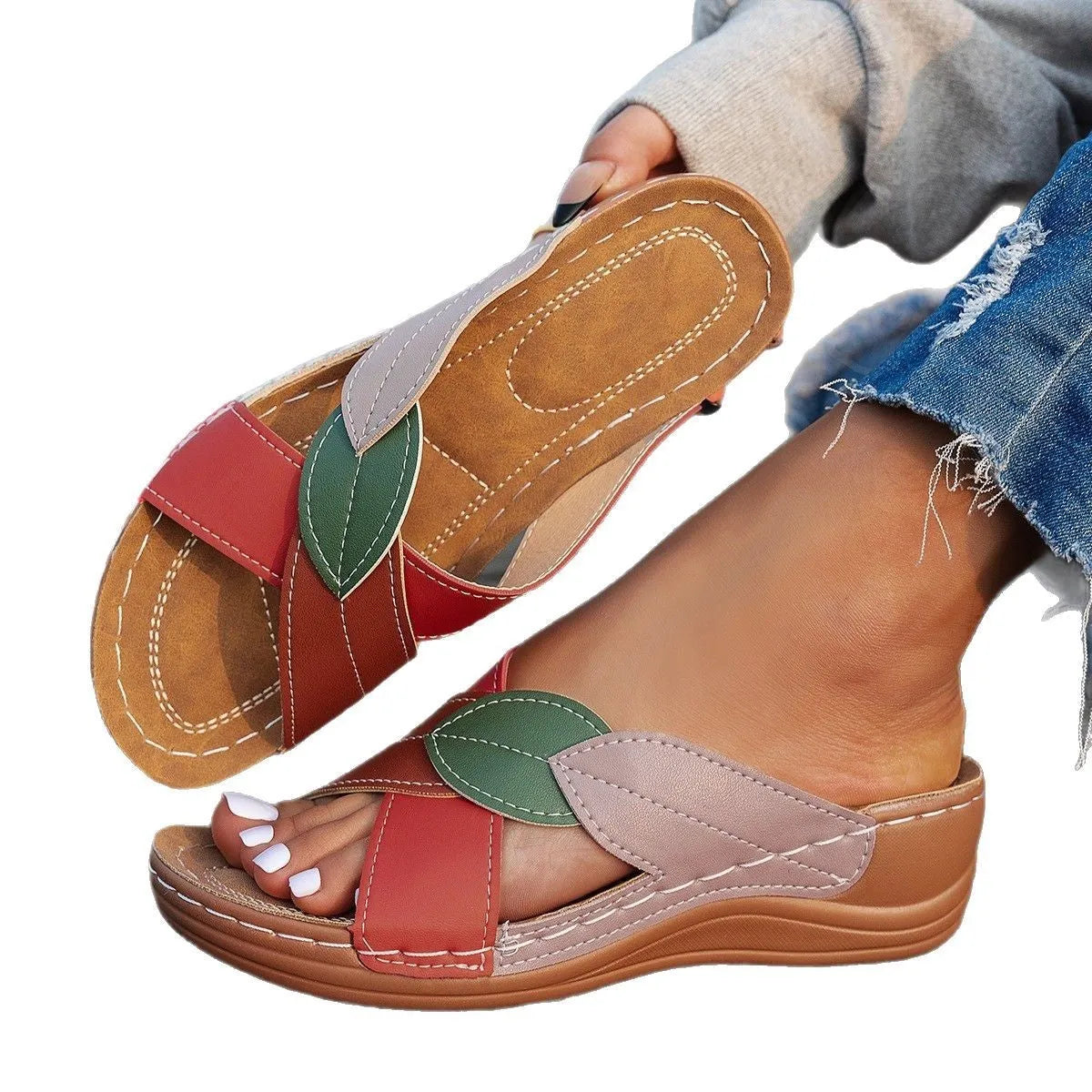 Women's black thick-soled slippers with a cross-strap and peep-toe design on a light background