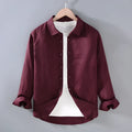 Men's solid colour linen cardigan shirt on a hanger, showing long sleeves.