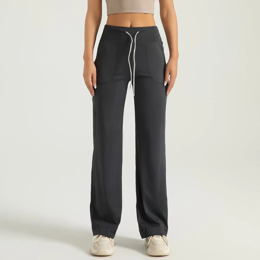 Women's high waist loose fit drawstring sports trousers in Star Black, side view, with elastic waistband and straight leg.