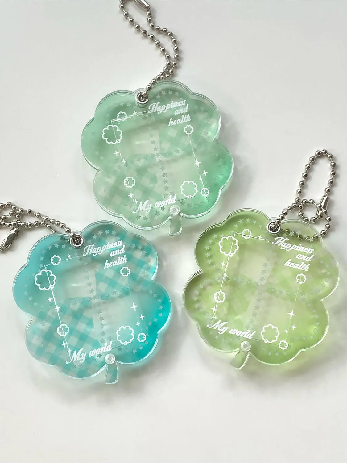Acrylic four-leaf clover charm pendant keychain in blue, green, and mint colour options