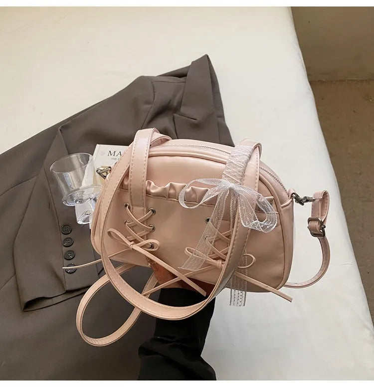 Women's bandage bow handbag in PU leather with shoulder strap and sewing thread detail