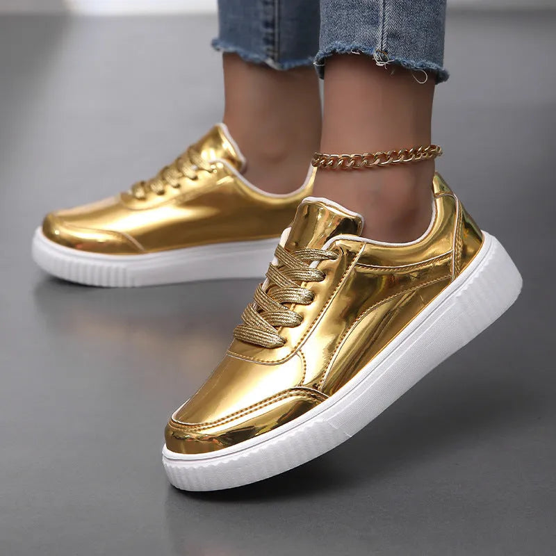 Gold sequinned platform sneakers with thick sole and round toe on a white background.