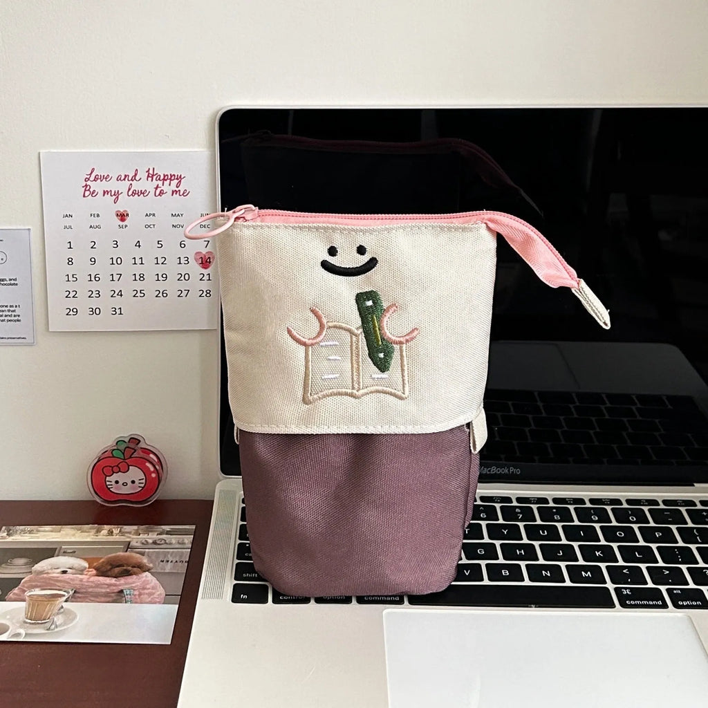 Brown Korean-style cartoon collapsible pencil case made from Oxford fabric, shown open to display its large capacity.