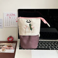 Brown Korean-style cartoon collapsible pencil case made from Oxford fabric, shown open to display its large capacity.