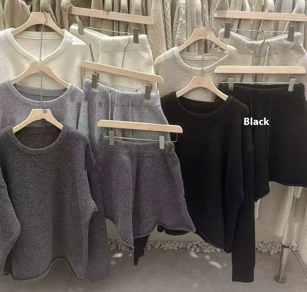 Women's loose grey acrylic knit sweater and wide-leg shorts set laid flat.