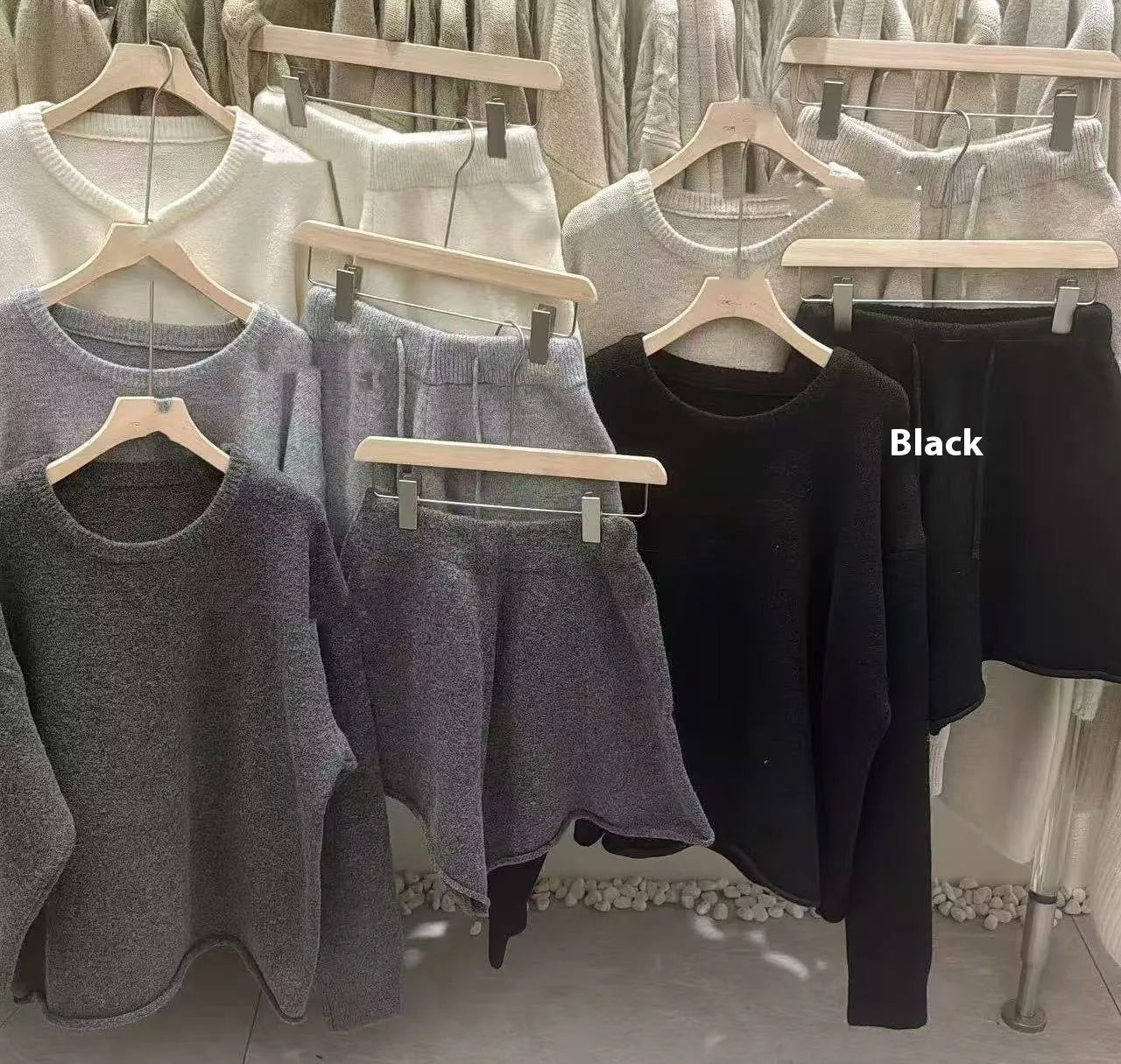Women's loose grey acrylic knit sweater and wide-leg shorts set laid flat.