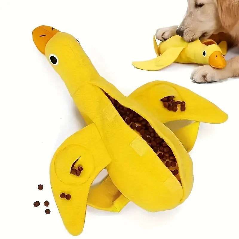 Yellow plush duck dog training toy with a squeaker and treat compartments on a white background.