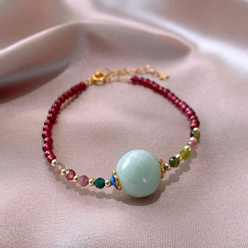 Aquamarine garnet bracelet with drop-shaped tourmaline centrepiece on wrist