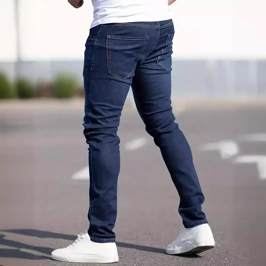 Men's dark blue slim fit skinny jeans on a hanger, showing mid waist and zipper fly detail.