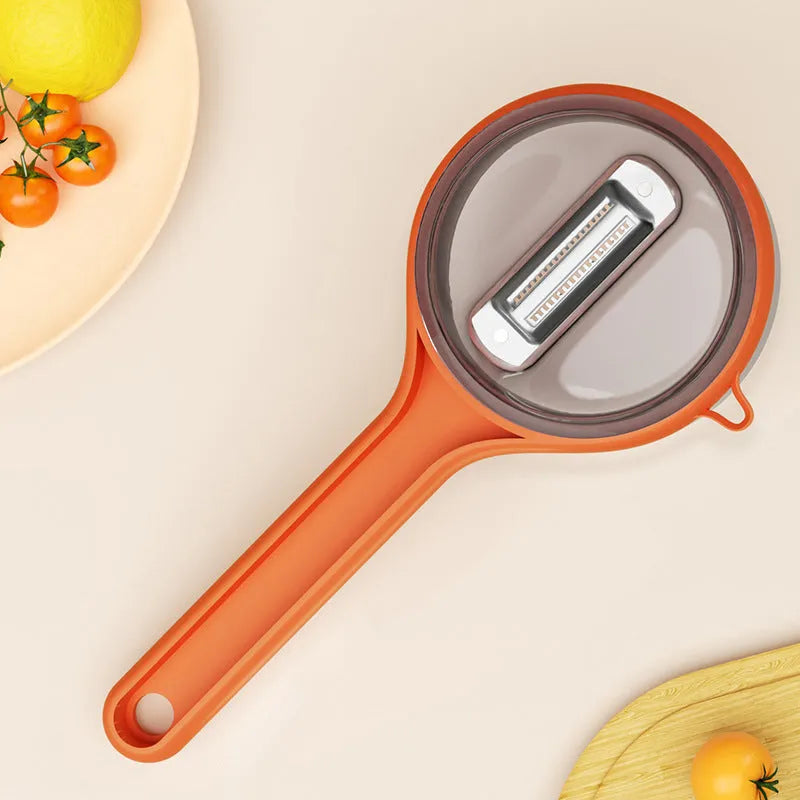 Light green kitchen peeler with integrated bucket storage for catching vegetable and fruit peels