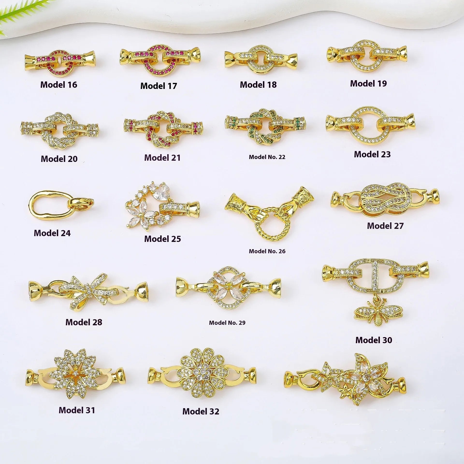 Small gold-colour electroplated metal jewellery buckle clasp on a white background.