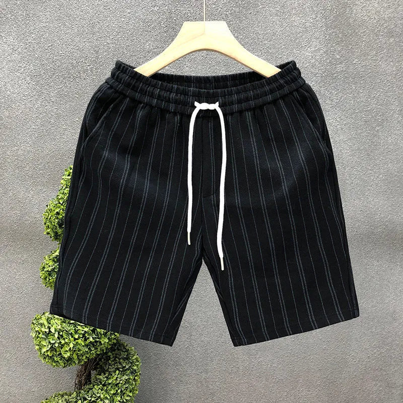 Men's black and white striped casual polyester shorts with an elastic waistband.