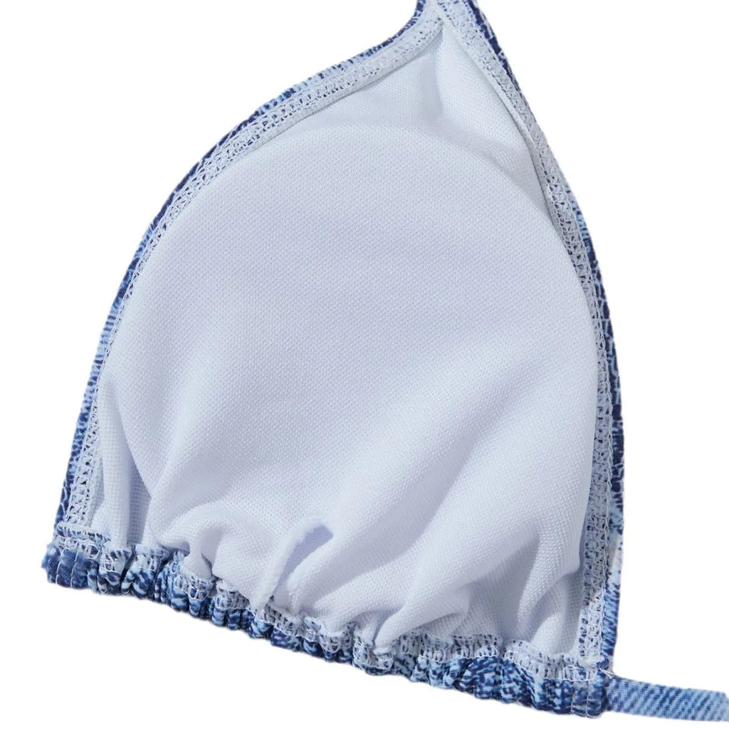 Women's denim blue printed bikini set with strap design on a hanger.