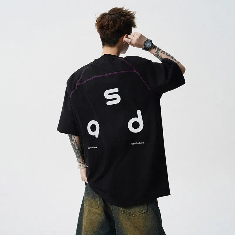 Loose fit black cotton t-shirt with white letter print, short sleeves, and round neck.