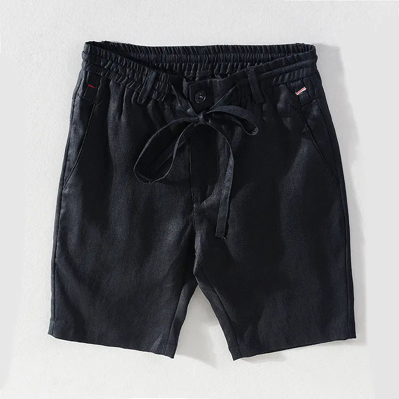 Men's 100% linen straight shorts in black, front view, mid-waist with zipper fly and pocket detail