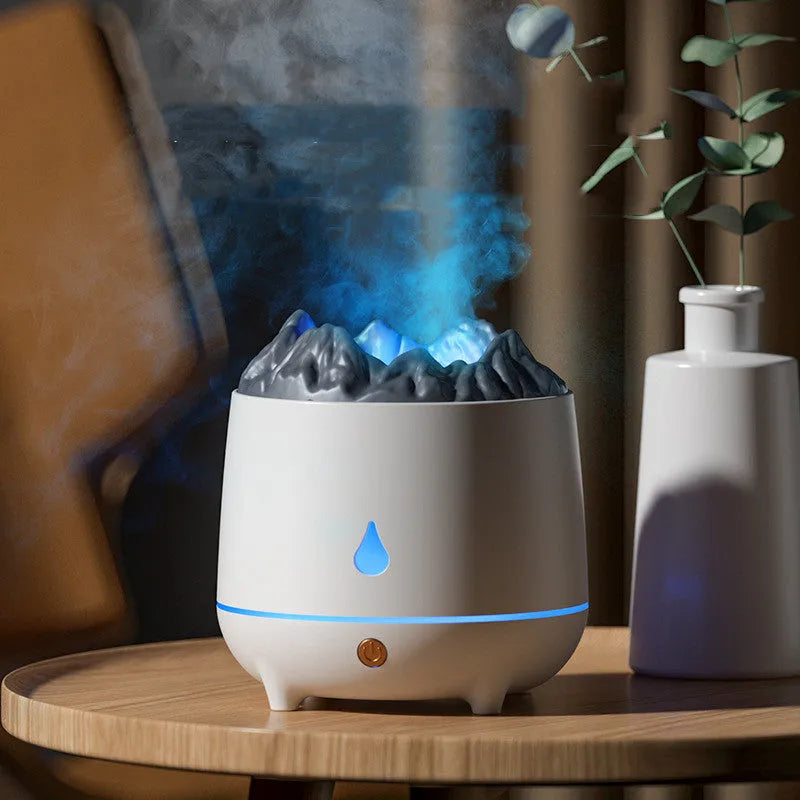 White volcanic-shaped ultrasonic humidifier and aromatherapy diffuser with USB cable on a table.