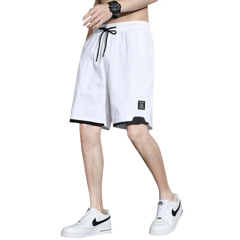 Boys' loose-fitting cotton summer shorts in black, shown on a hanger.
