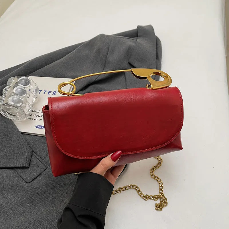 Creative personality paper clip shoulder handbag in PU leather with sandwich pocket and file bag interior.