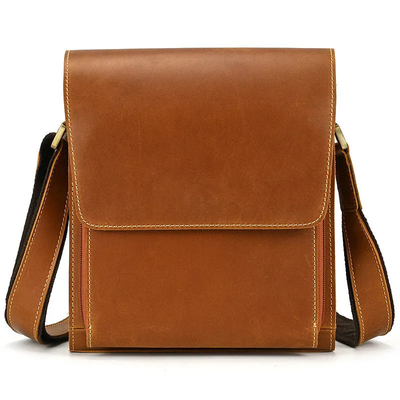 Men's brown leather shoulder bag with flip shoulder strap showing sewing line details and retro design