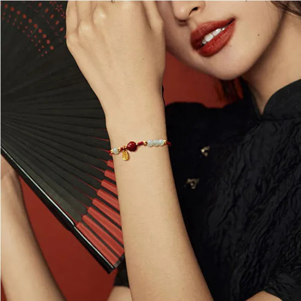Handmade women's bracelet with cinnabar red rope, 925 silver, and Hetian jade on an adjustable chain.