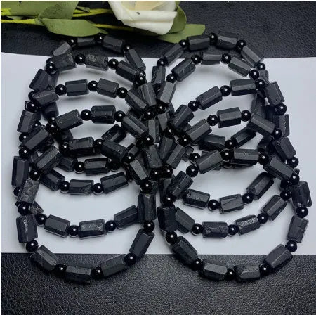 Natural black tourmaline rough stone bracelet with polished beads on wrist