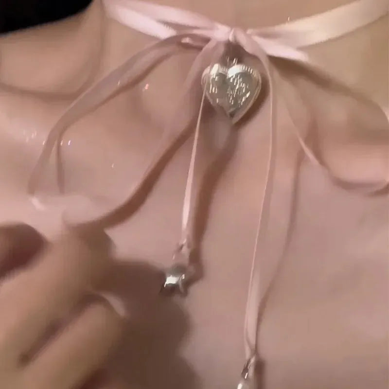 Women's alloy fashion necklace with a love pendant and ribbon detail on a clavicle chain.