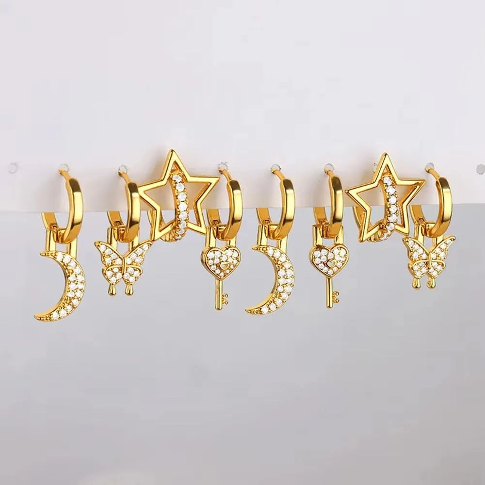 Women's geometric butterfly-shaped copper earrings with heart and star details in various colours.