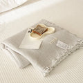 Four-layer gauze cotton blanket with tassel trim in a choice of ten colours and two sizes.