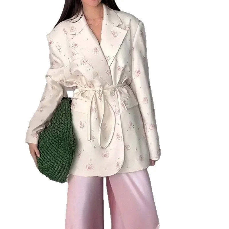 Women's white suit jacket with a lace-up detail on the collar and an adjustable waist tie, shown in a regular fit with long sleeves.
