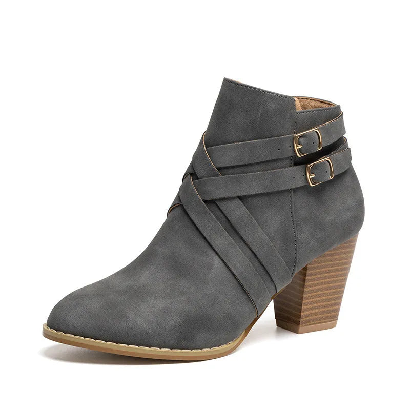 Plus size black short boot with side zipper, buckle, and a 7cm thick rubber heel.