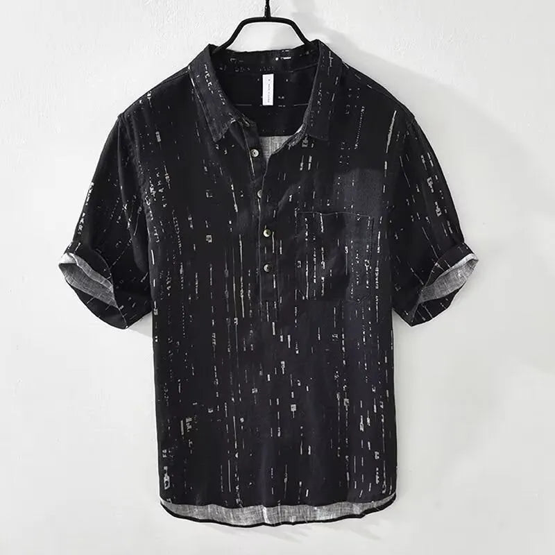 Man wearing a black loose-fit short-sleeved lapel polo shirt, a cardigan-style casual top.