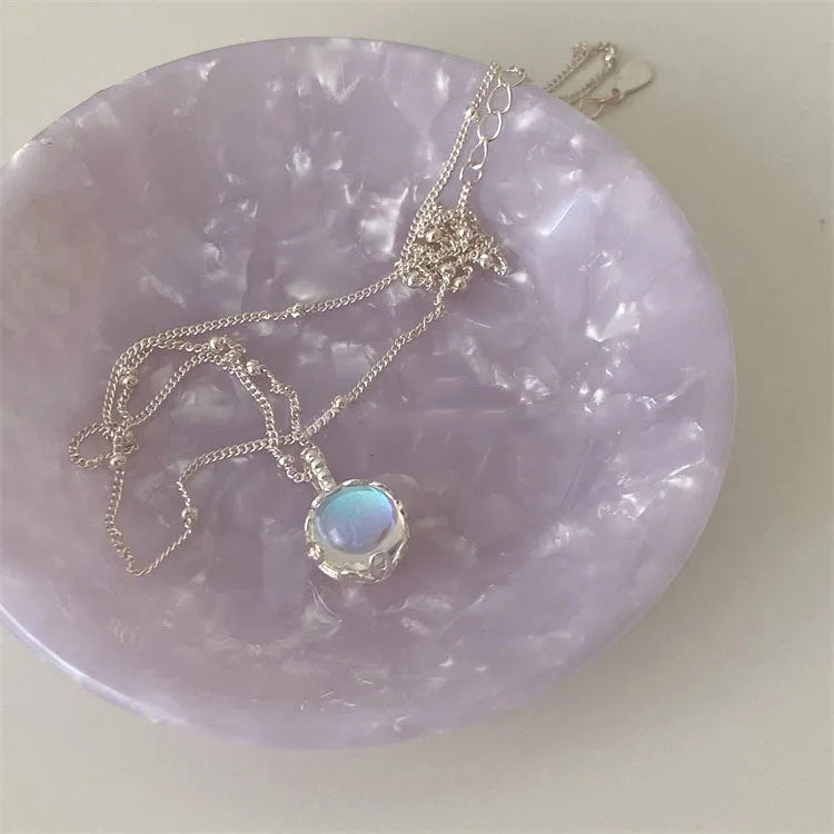 Women's ornamental stone necklace with round 925 silver pendant on a silver curb chain, adjustable length.