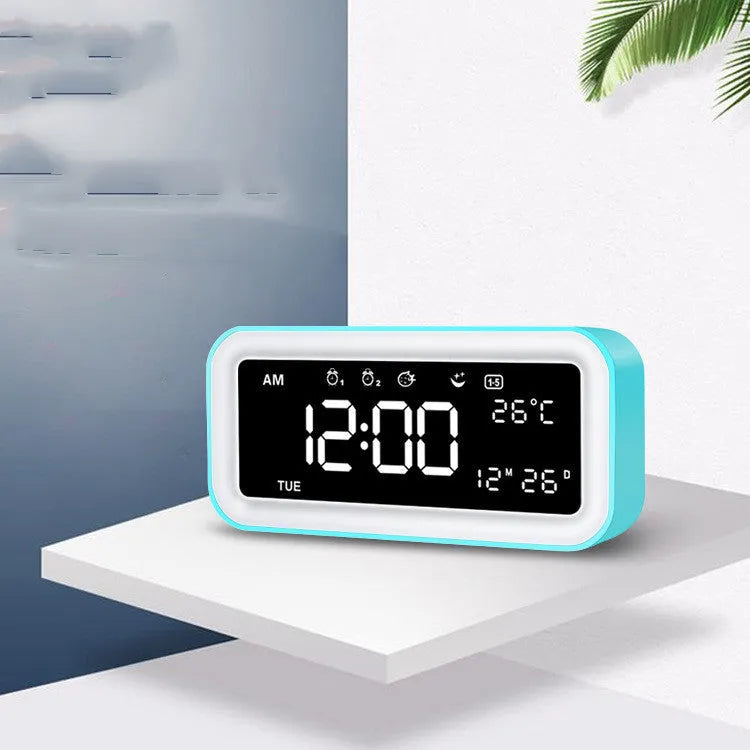 Rectangular blue and pink multifunctional LED atmosphere alarm clock with digital display and quartz glass mirror.