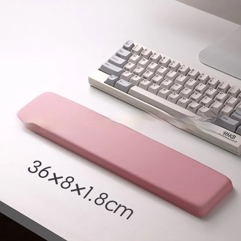 Square black silica gel mouse pad with raised keyboard support area and integrated wrist rest on a wooden desk.
