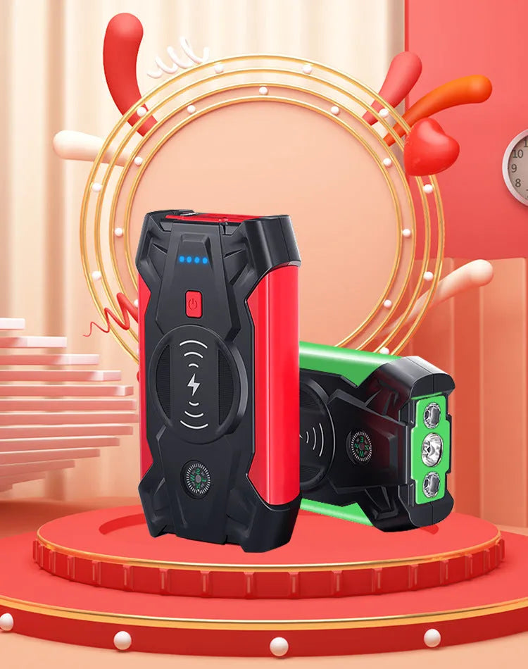 Red portable car battery jump starter with digital display, crocodile clips, and air pump hose.