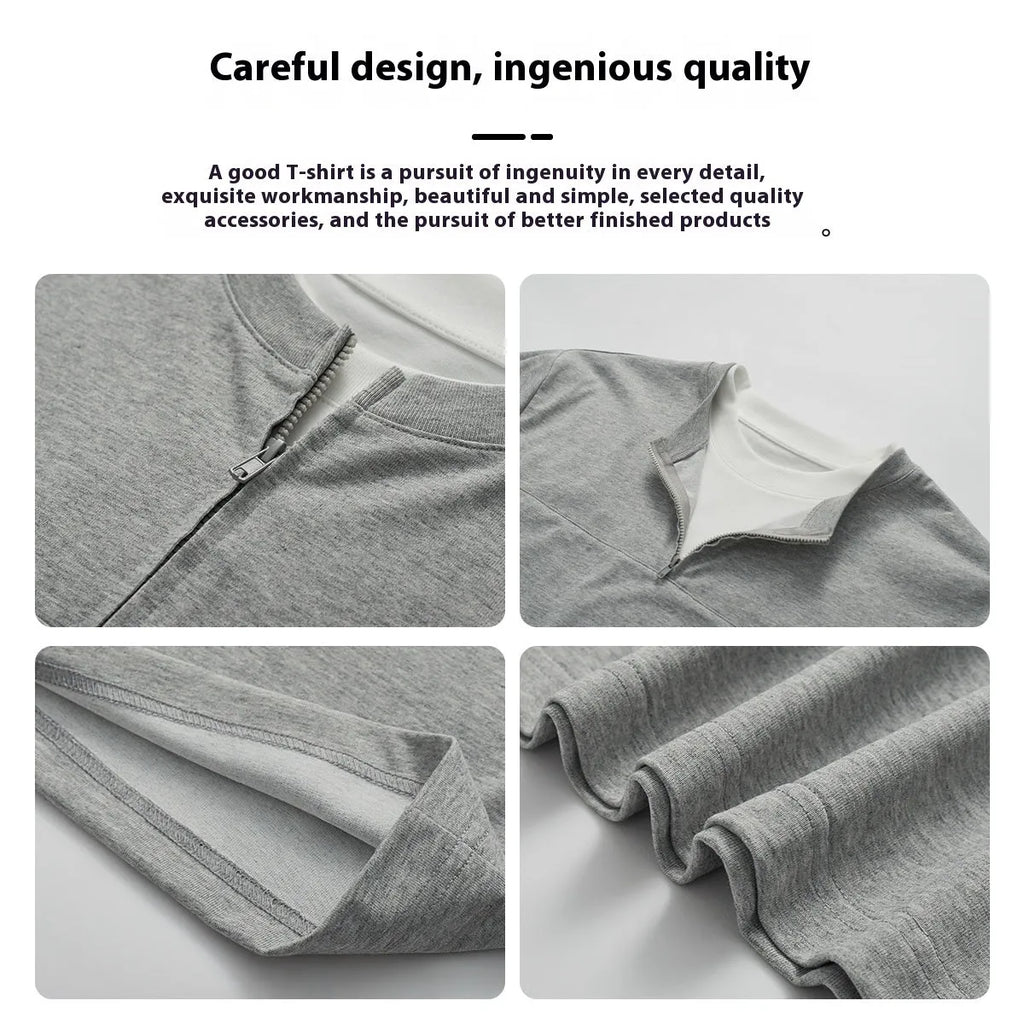 A solid colour loose-fitting casual top with zip detail and patchwork styling on a hanger.