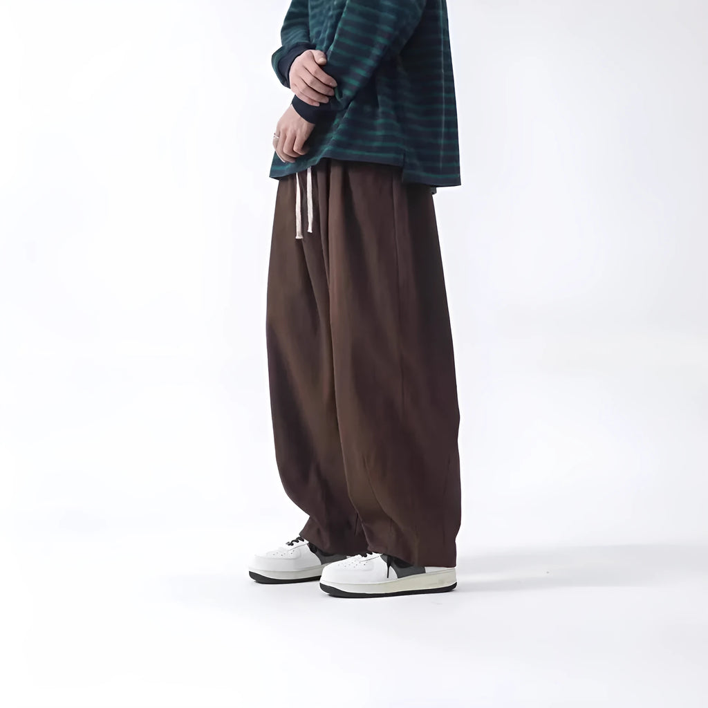 Cotton men's loose wide leg drawstring trousers in black and brown straight leg style with mid waist