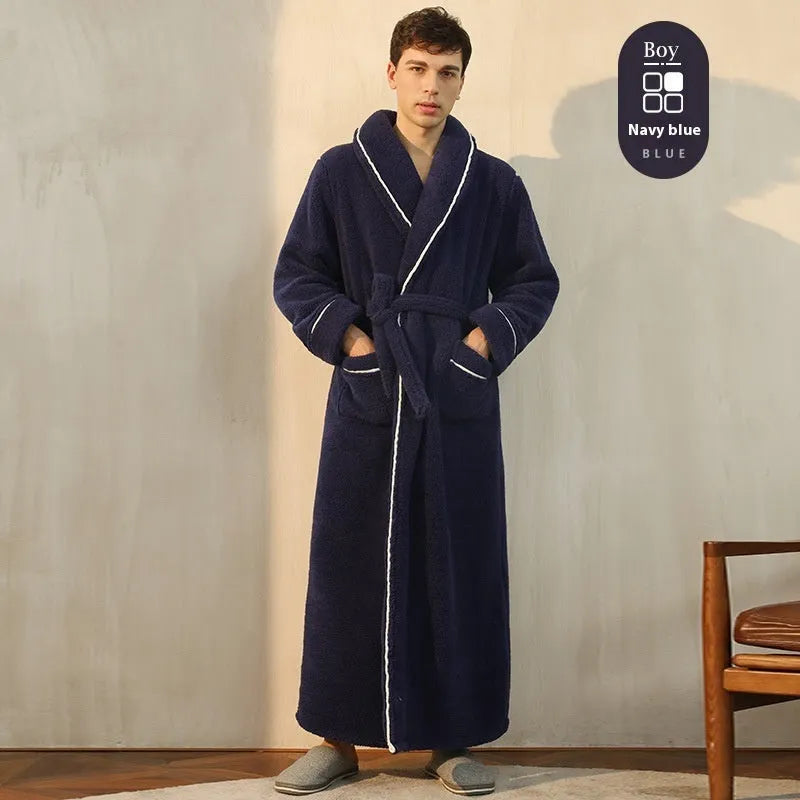 A man and woman wearing matching navy blue thick flannel bathrobes, showcasing the wrap-around design and plush fabric.