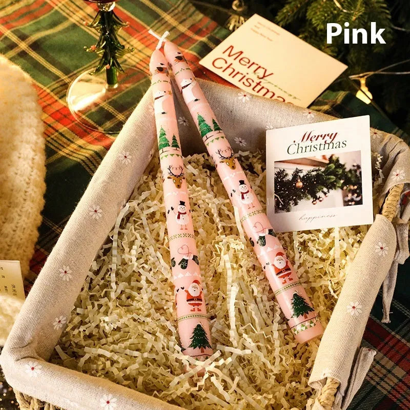 Cylindrical Christmas printed paraffin candle in bright red, 2.2 x 25 cm, on a wooden table