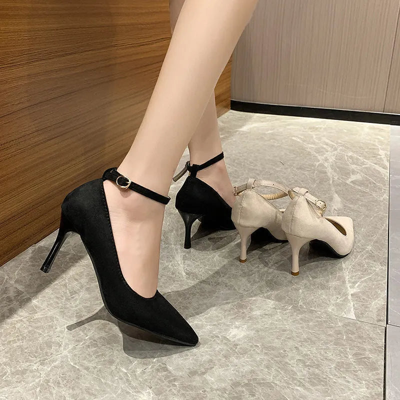 Black women's stiletto heel pump shoe with a skull pattern and a buckle fastening.