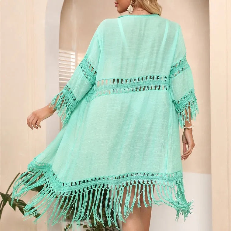 Women's yellow crochet cardigan beach cover-up with tassel details on mannequin