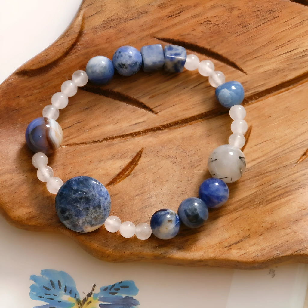 Hand-woven unisex bracelet with blue point stone and black hair crystal agate in a geometric design.