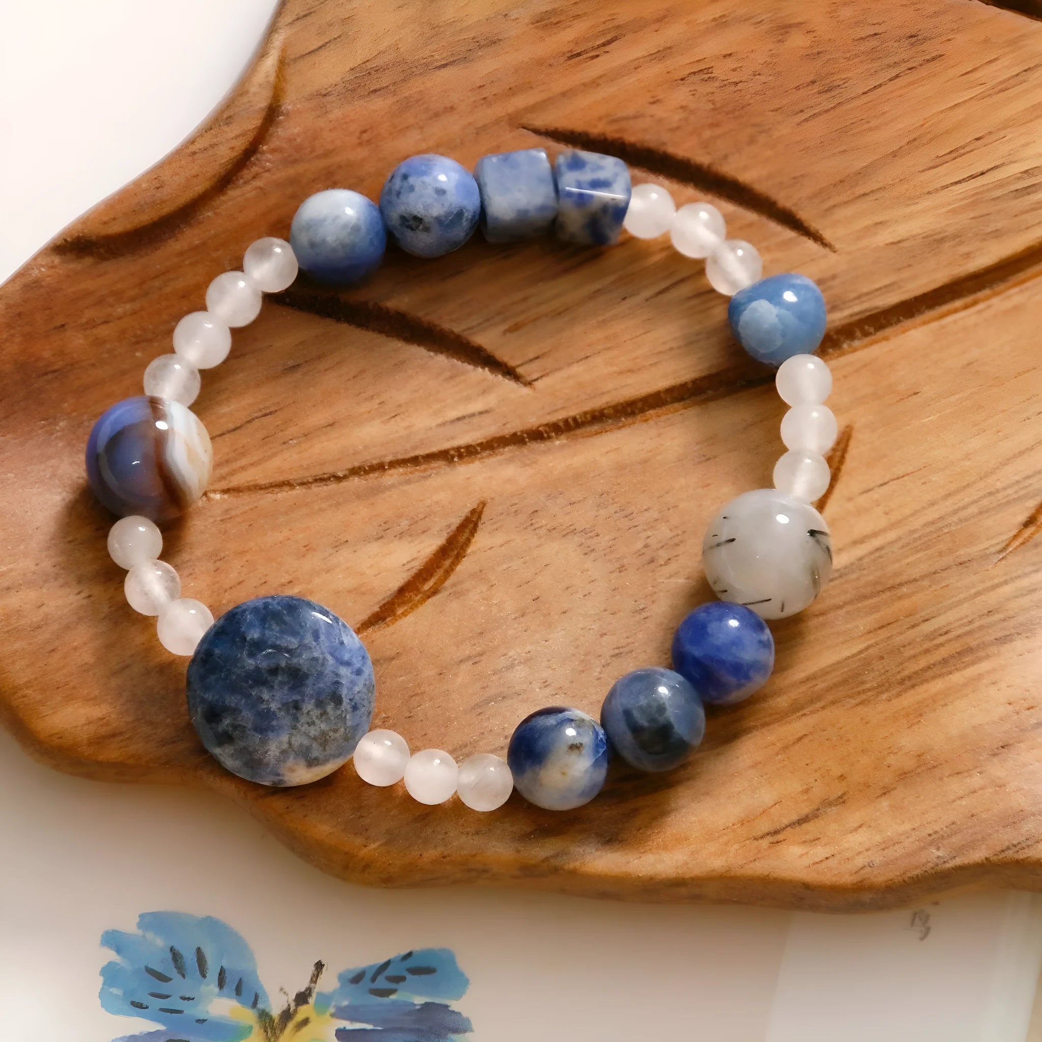 Hand-woven unisex bracelet with blue point stone and black hair crystal agate in a geometric design.